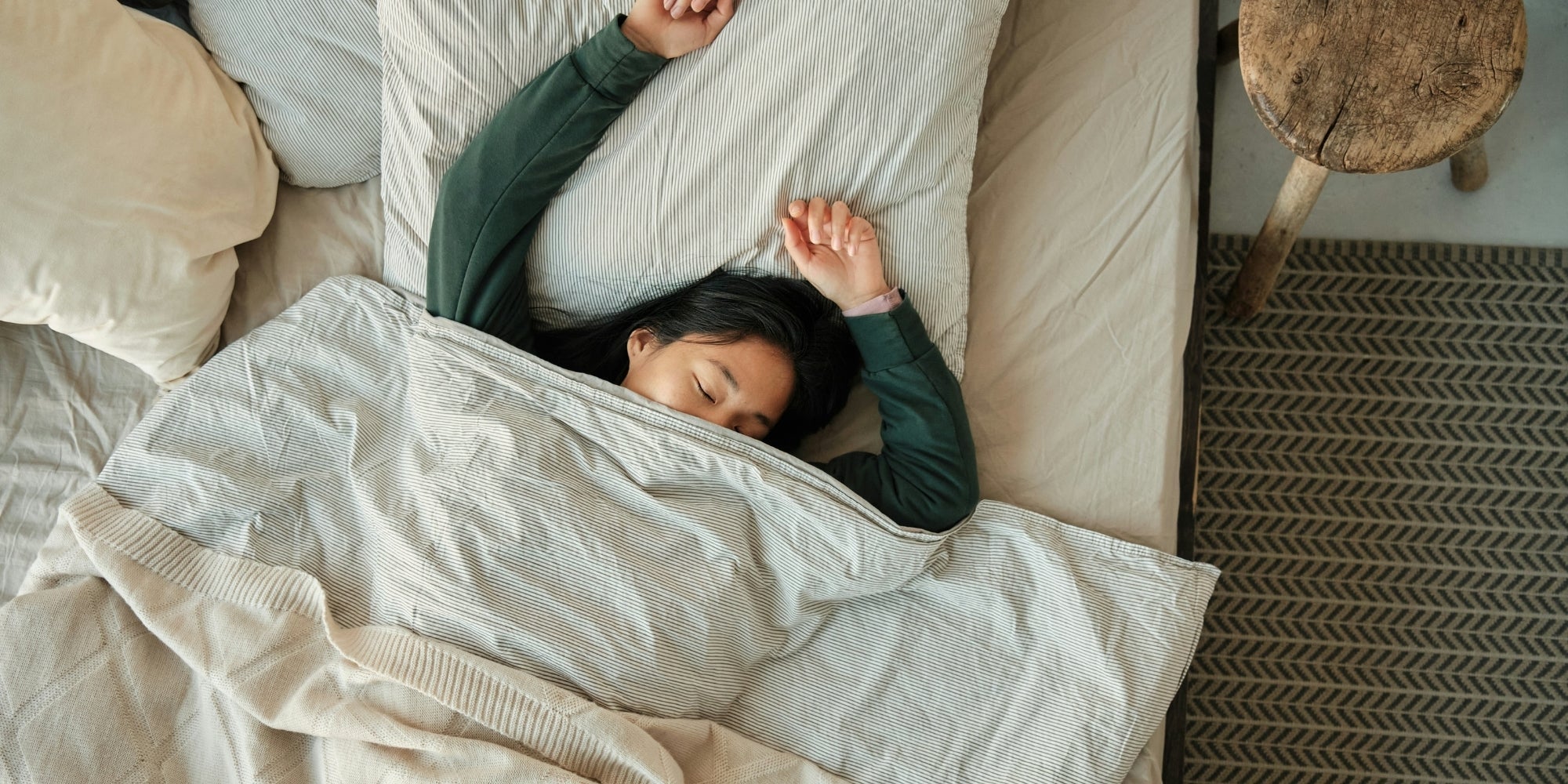 Woman laying uncomfortably in bed