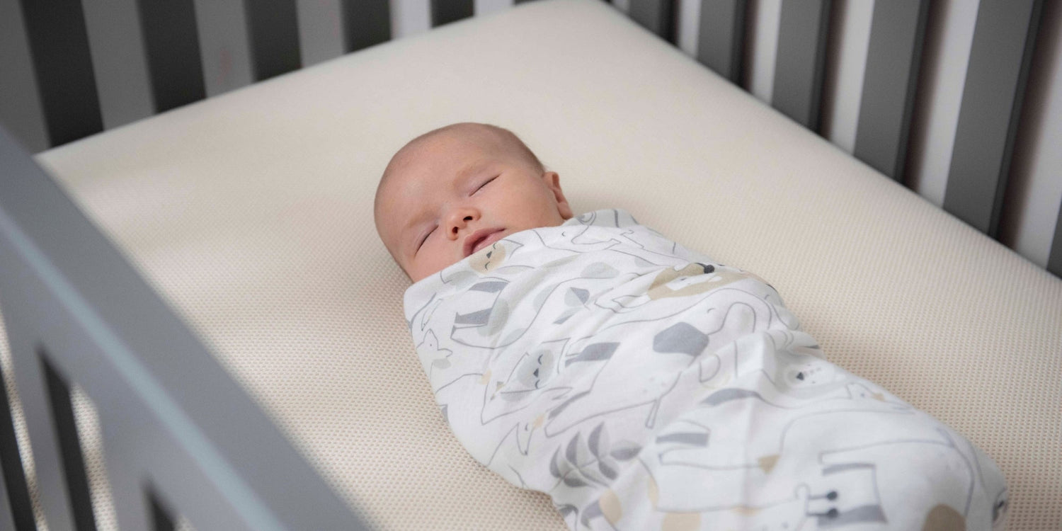 baby laying on firm crib mattress