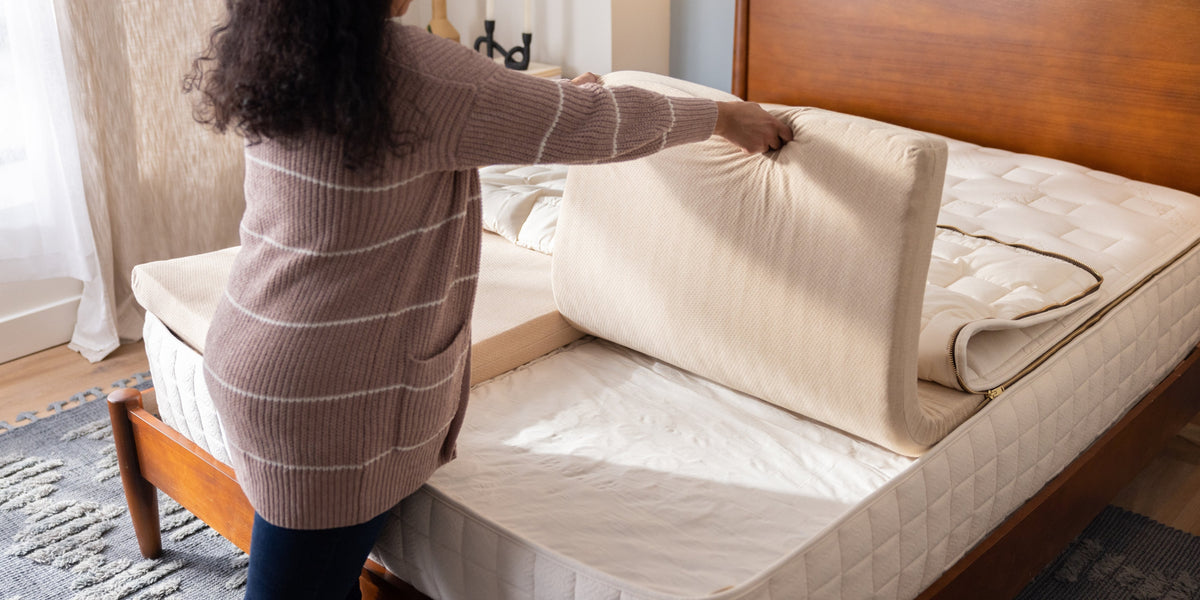woman holding organic latex layers of a customizable organic mattress