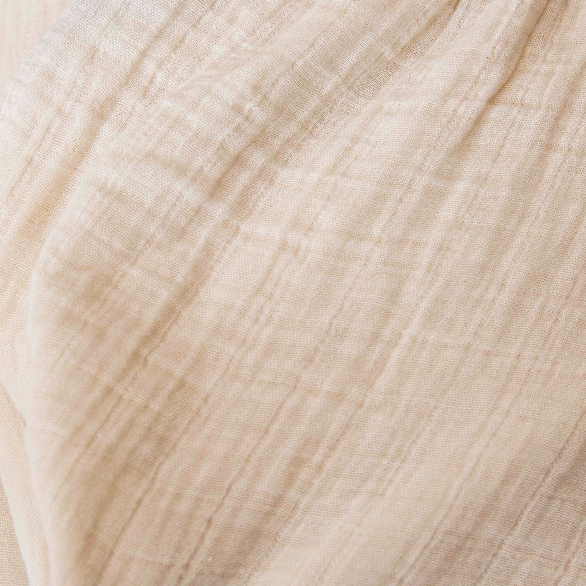Close-up of beige muslin weave texture