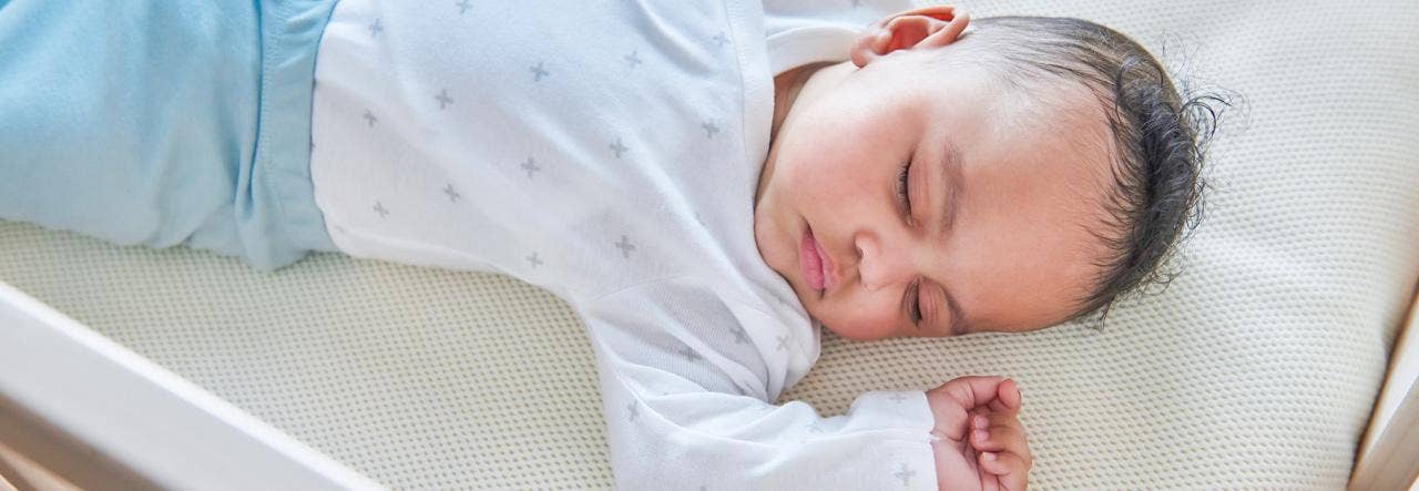 baby sleeping on NP crib mattress