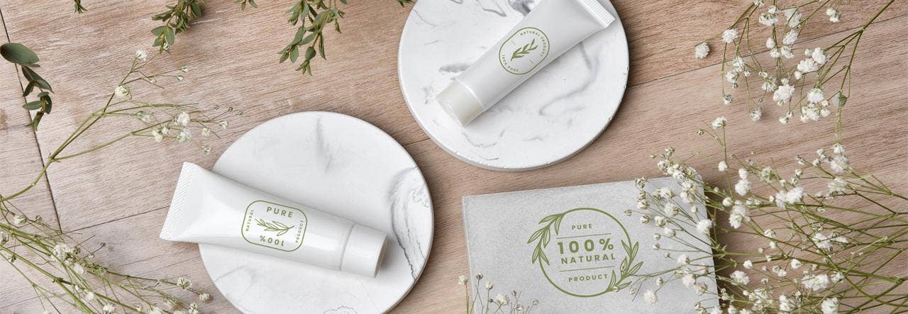 Natural-looking products labeled "100% pure" displayed on a wooden table