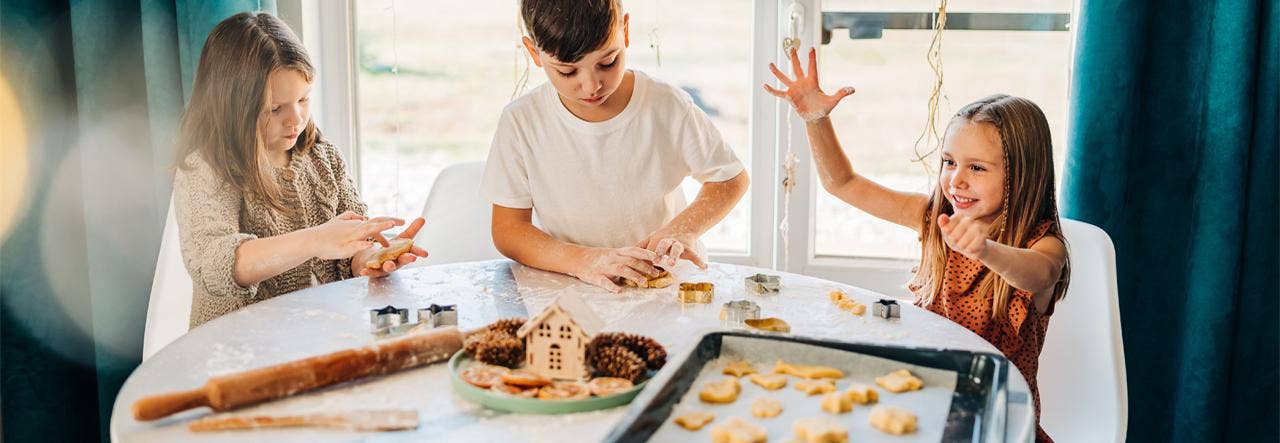 Children making cutout cookies for the holidays