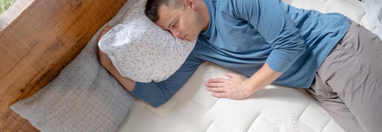 Man sleeping soundly on a bare organic mattress