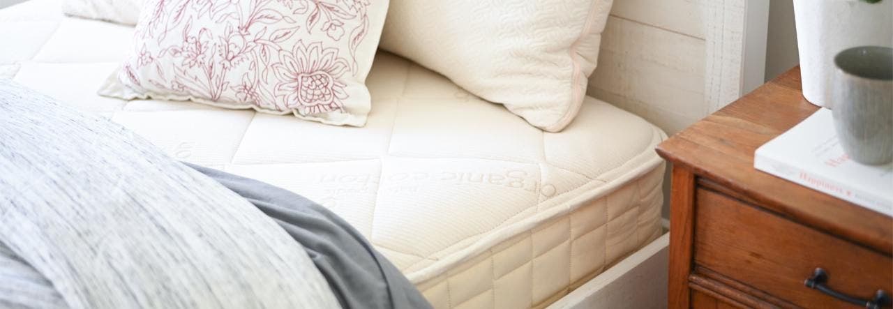 Clean Naturepedic EOS organic mattress on a bed