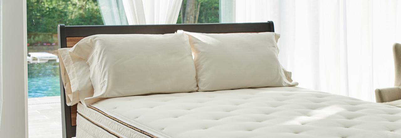 Naturepedic organic pillows on a bed with a Naturepedic Organic mattress