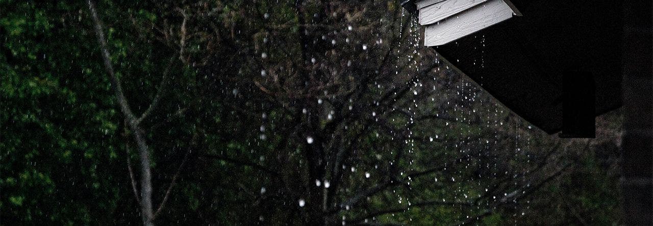 Rain dripping over a rooftop