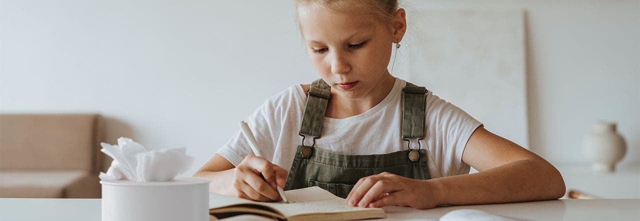 Child doing homework at the kitchen table