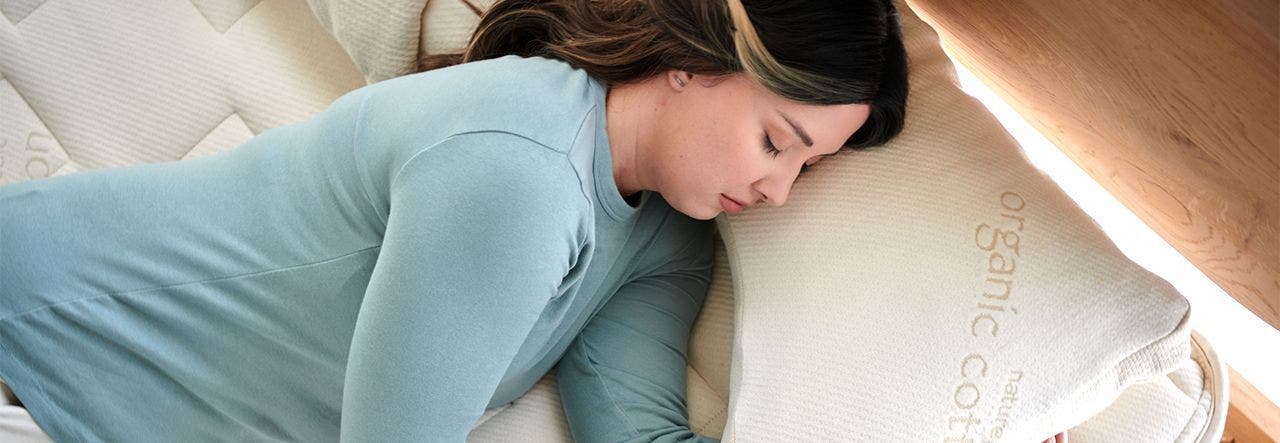 Woman sleeping soundly on her side on a side sleeper pillow