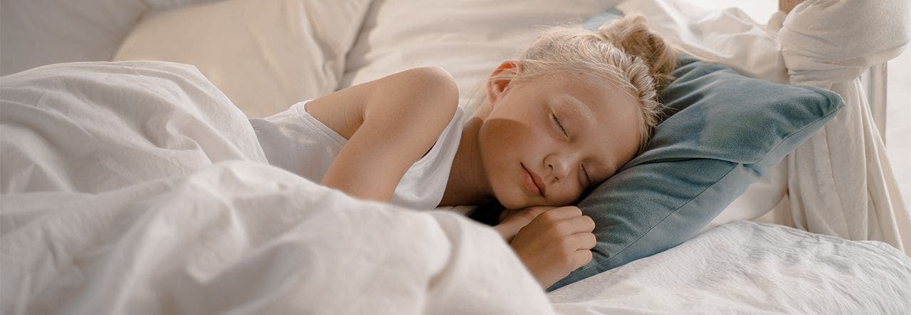 School-aged child sleeping soundly in a healthy sleep space