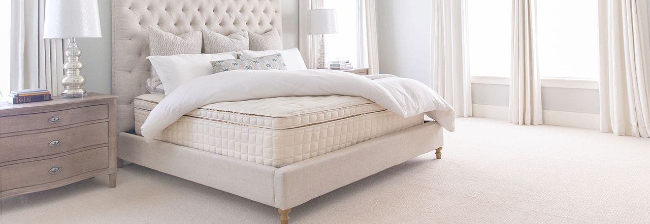 Sustainable organic mattress set up in a clean, naturally lit bedroom