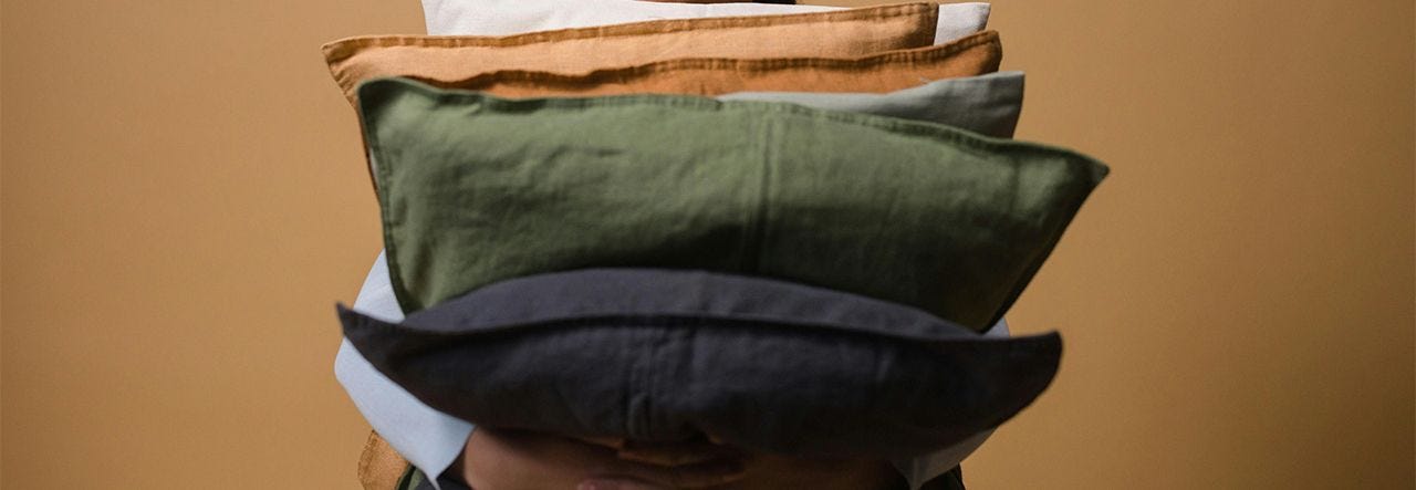 Woman fluffing an old pillow