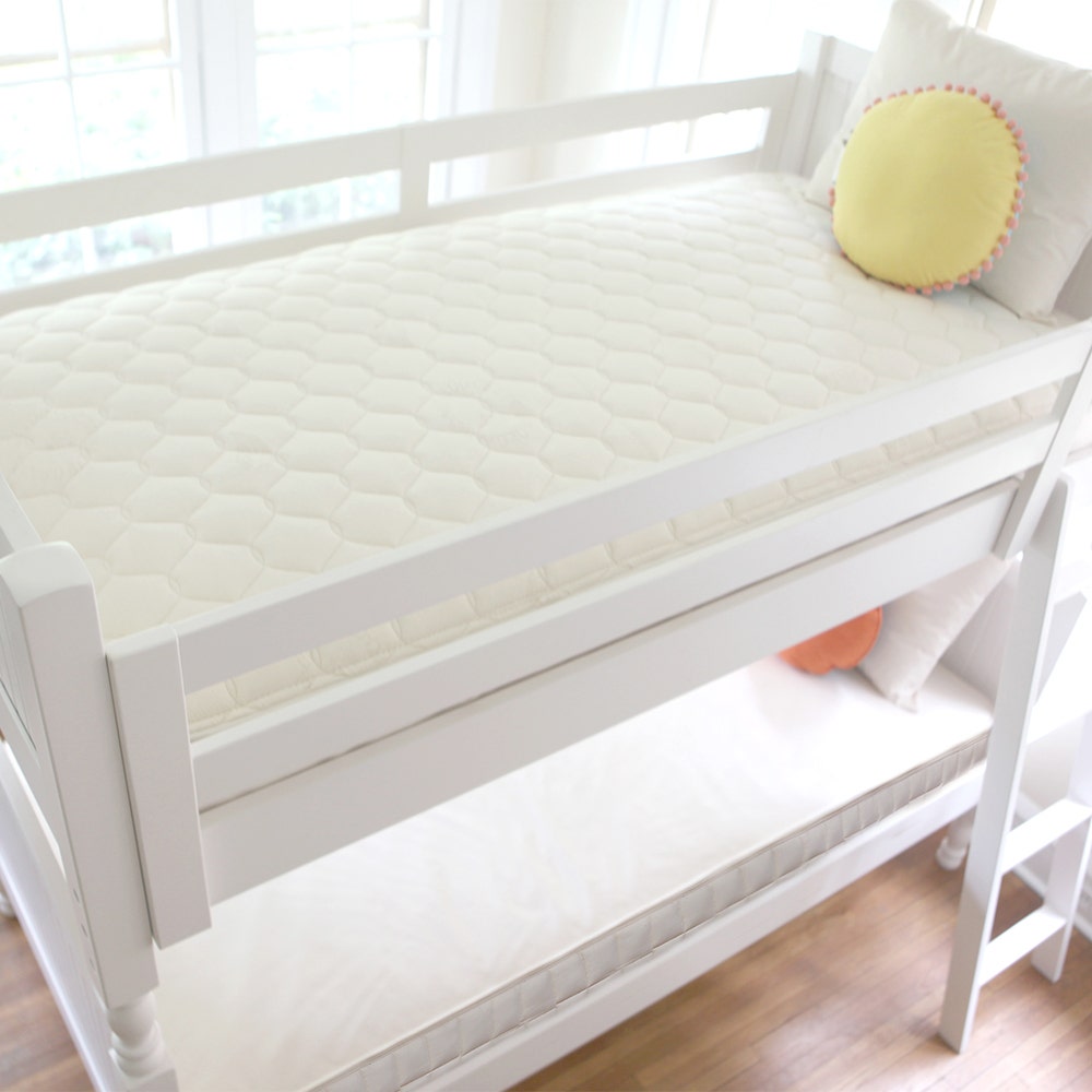 Woman laying in bed with body pillow