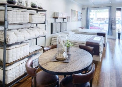 mattresses and accessory rack inside organic mattress gallery in Los Angeles California