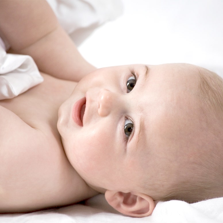 Close-up of baby's face while lying on back