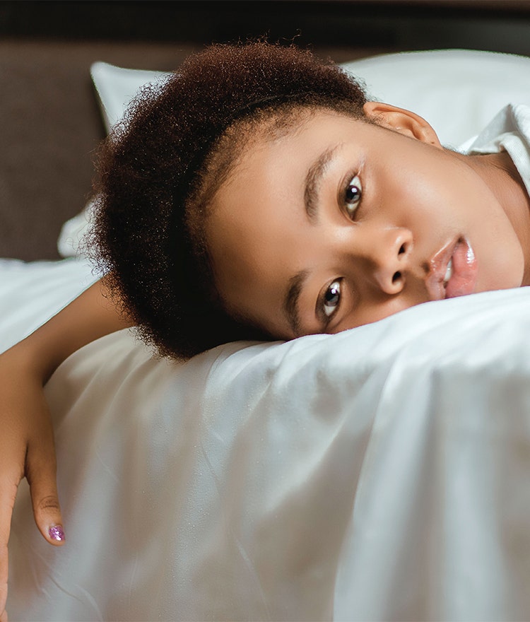 Woman lying on her stomach and looking exhausted