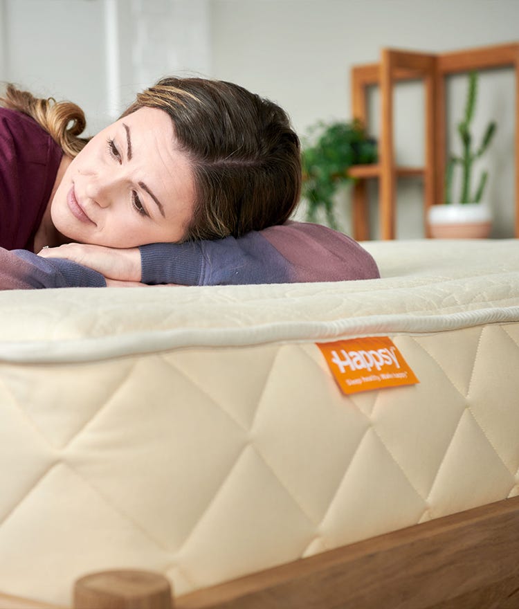 woman laying down on happsy organic mattress