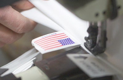 US flag being sewn into seam