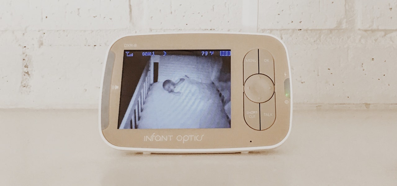 Baby monitor in a wooden surface, showing sleeping baby