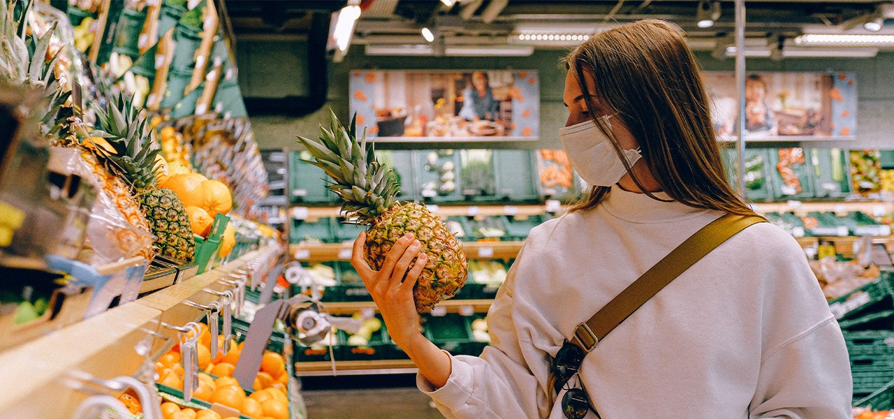 Woman picking out fresh, organic produce at the grocery store