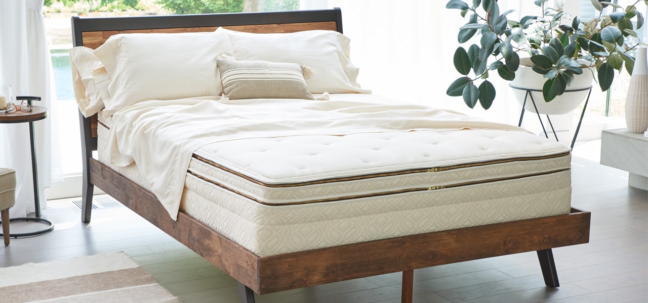 Wooden bedframe with Naturepedic organic mattress, sheets and pillows