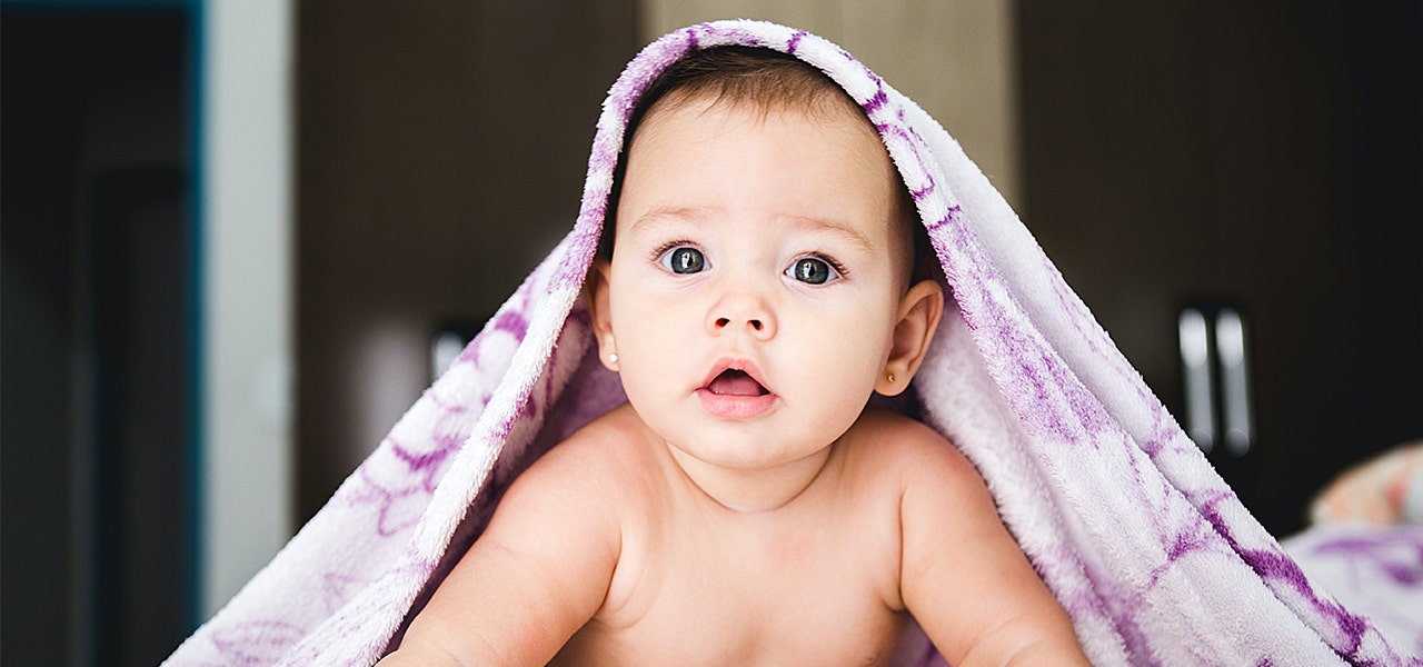 Alert baby, around 4 months old, raising herself during tummy 