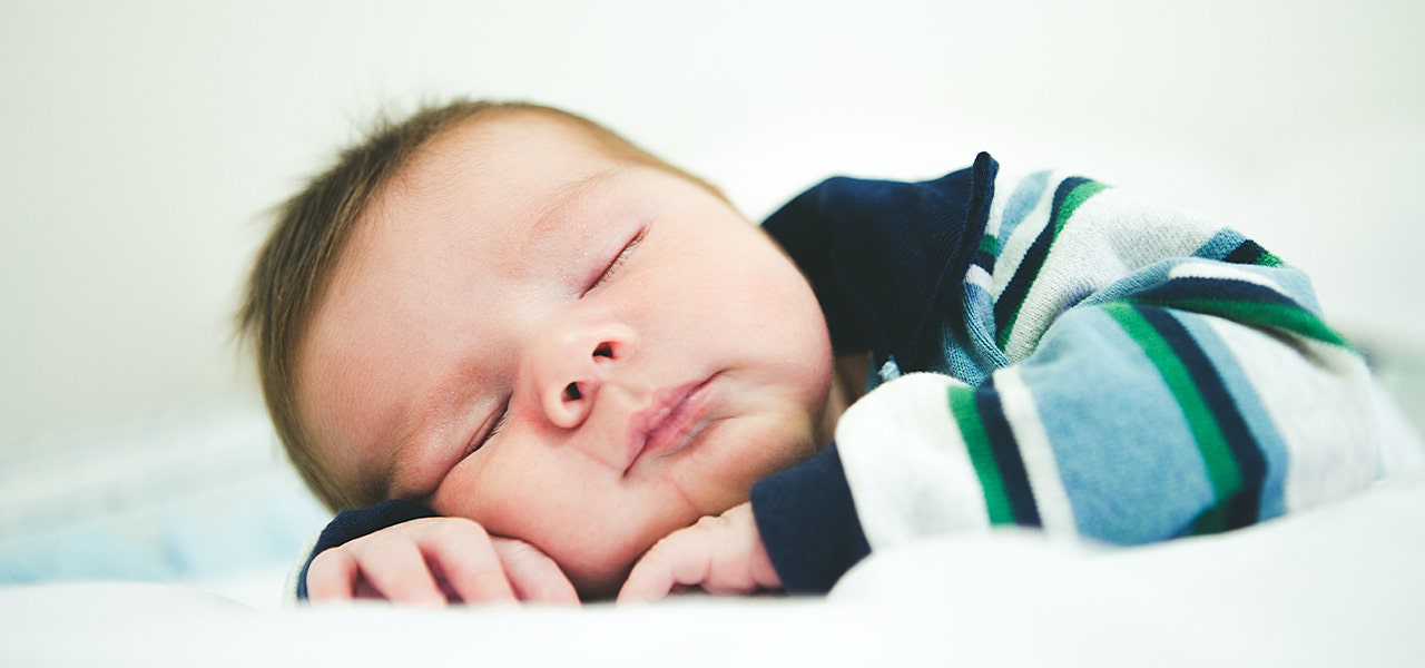 Baby sleeping soundly with head tuened to the side