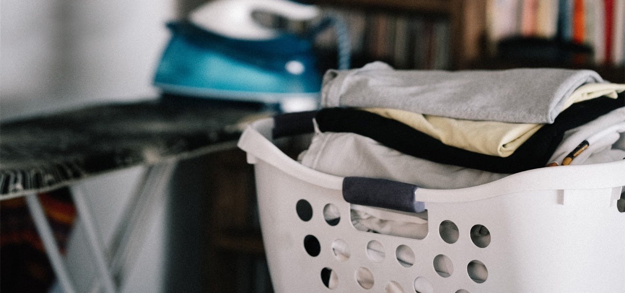 Full laundry basket in a cluttered space