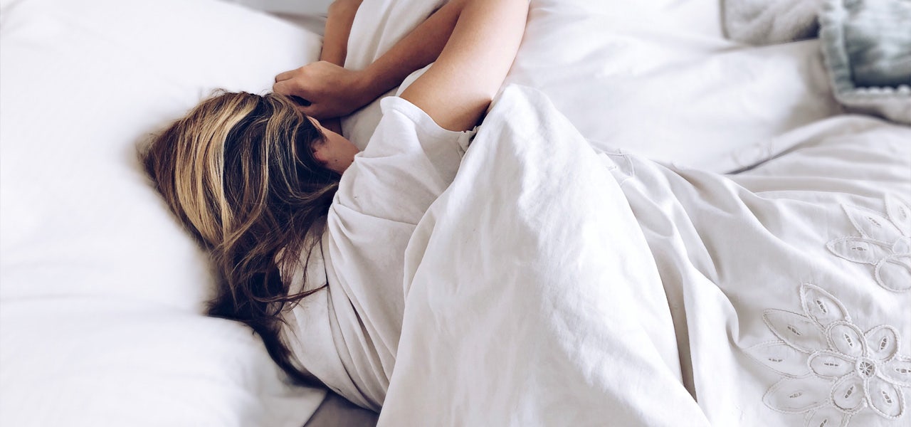 Woman sleeping comfortably with organic cotton bedding