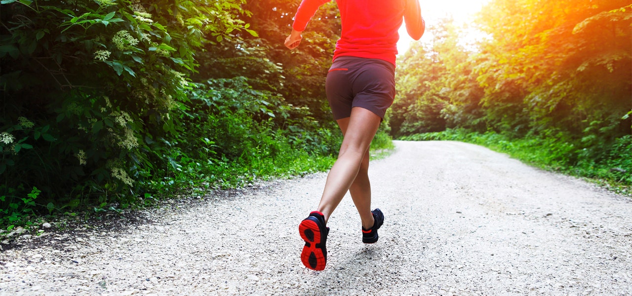 Woman running outdoors at sunset