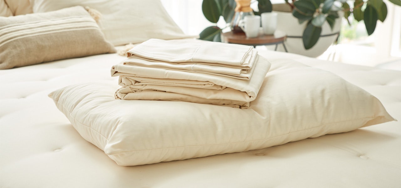 Naturepedic organic mattress, pillow, and folded cotton sheet set