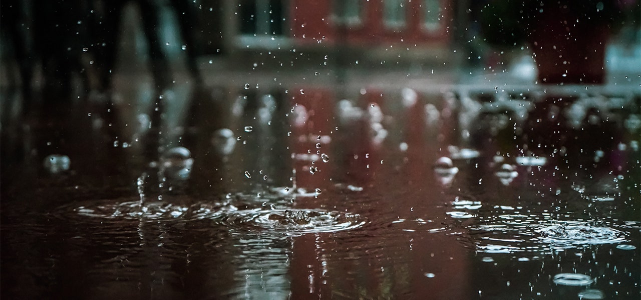 Raindrops splashing into a puddle