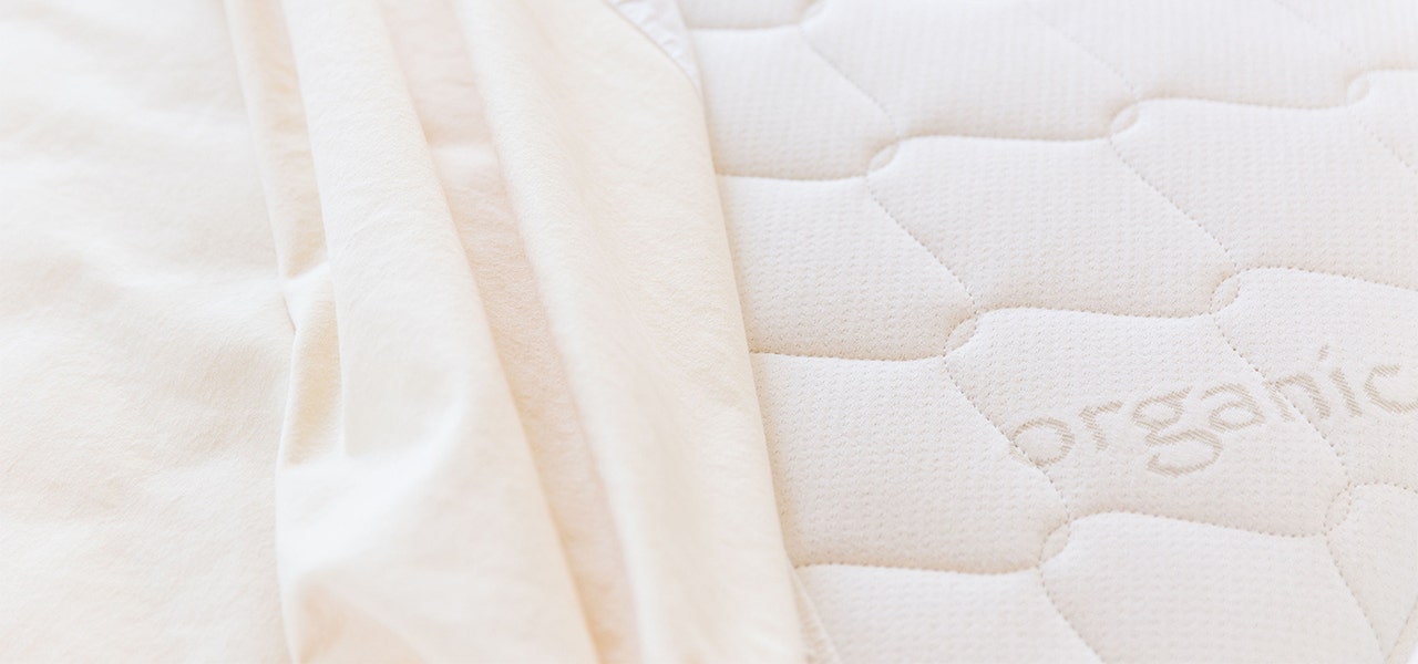 Close-up of a Naturepedic organic mattress and organic cotton sheet