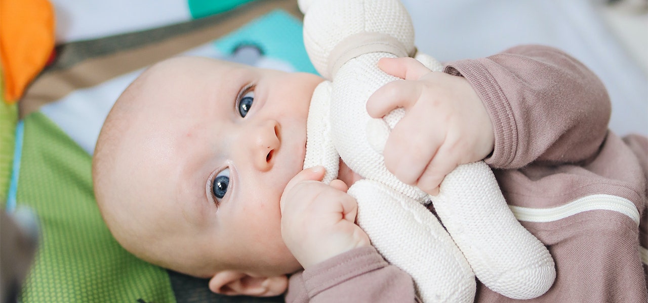 Baby chewing on an organic baby toy