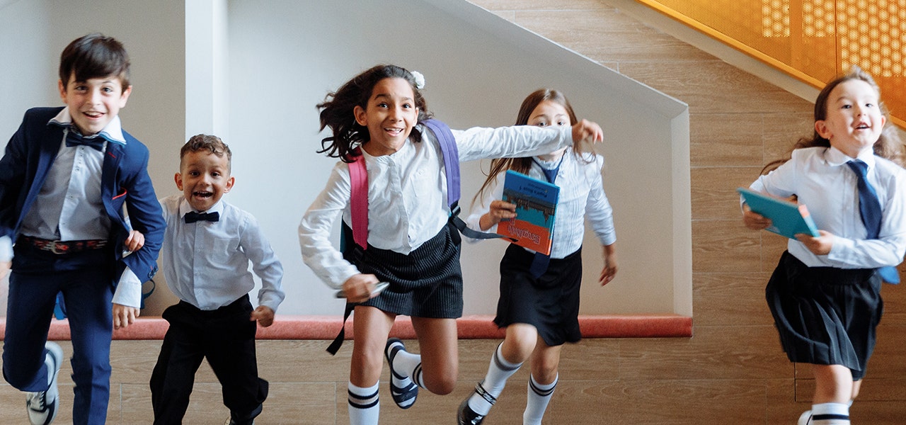 Healthy, happy kids running out of school at the end of the day