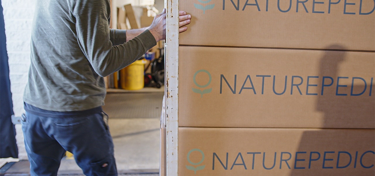 Volunteer unloading Naturepedic mattresses