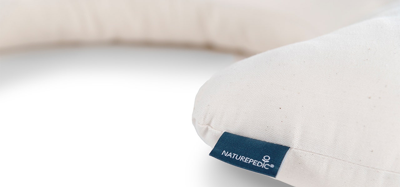 Naturepedic nursing pillow on a white background