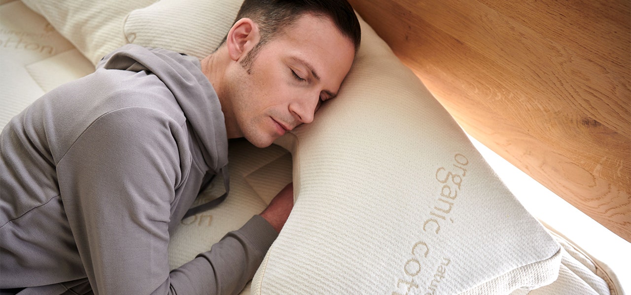 Man sleeping with a Naturepedic Organic Side Sleeper Pillow