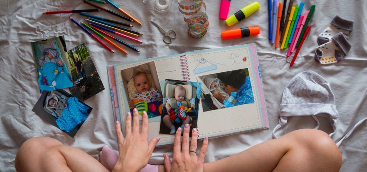 Person sitting cross-legged and working on a scrapbook