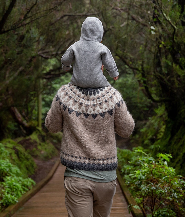 Father and child hiking on a trail