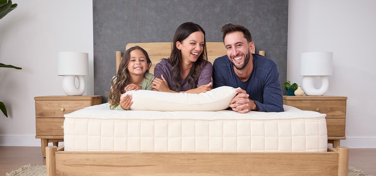 family laying on a naturepedic organic mattress