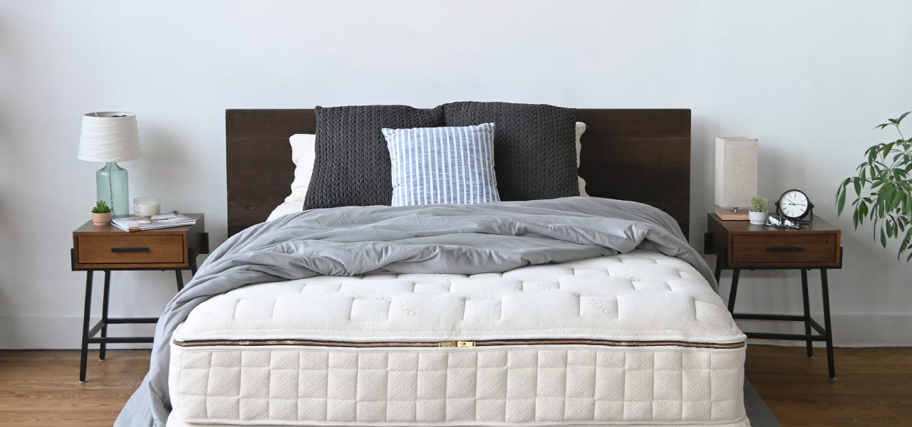 naturepedic organic mattress with grey bed sheet and pillows