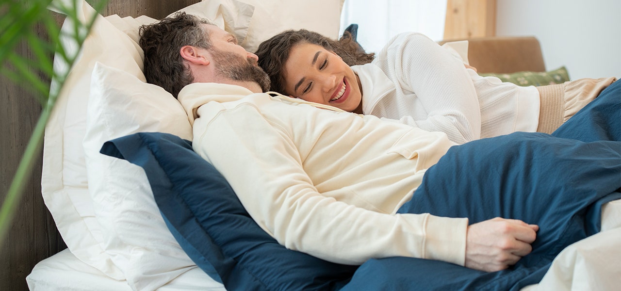 couple resting in bed together
