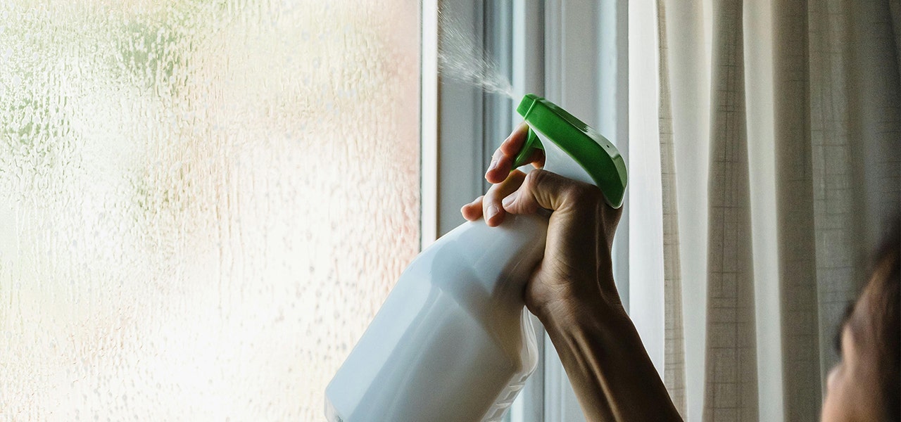 using spray bottle to sanitize window