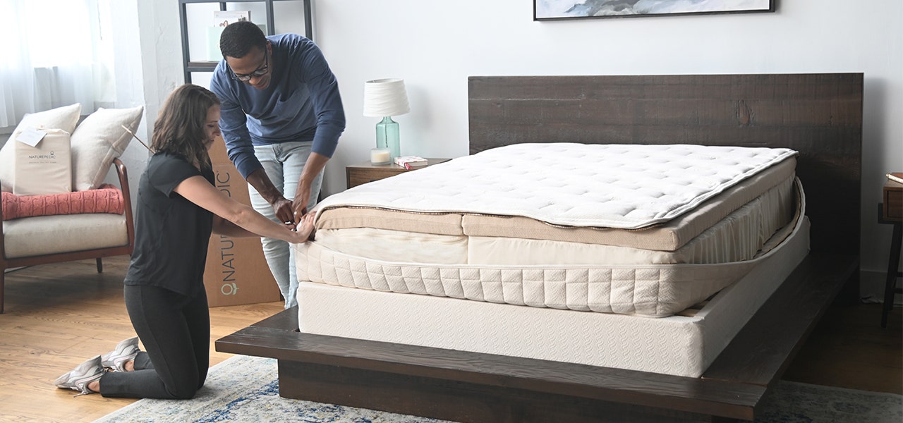 couple zipping layers of the naturepedic eos organic mattress