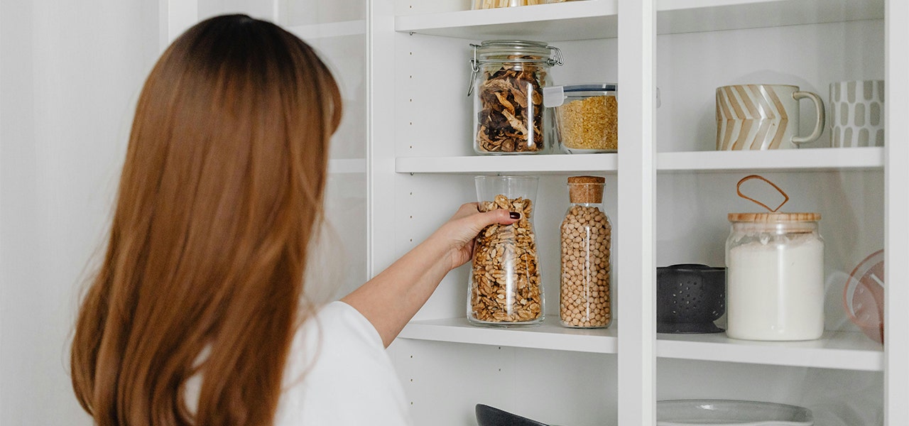 woman organizing food in glass jars