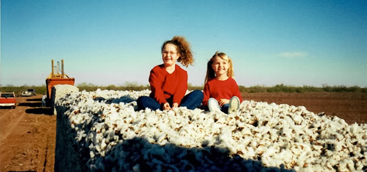 sisters on a truck full of organic cotton