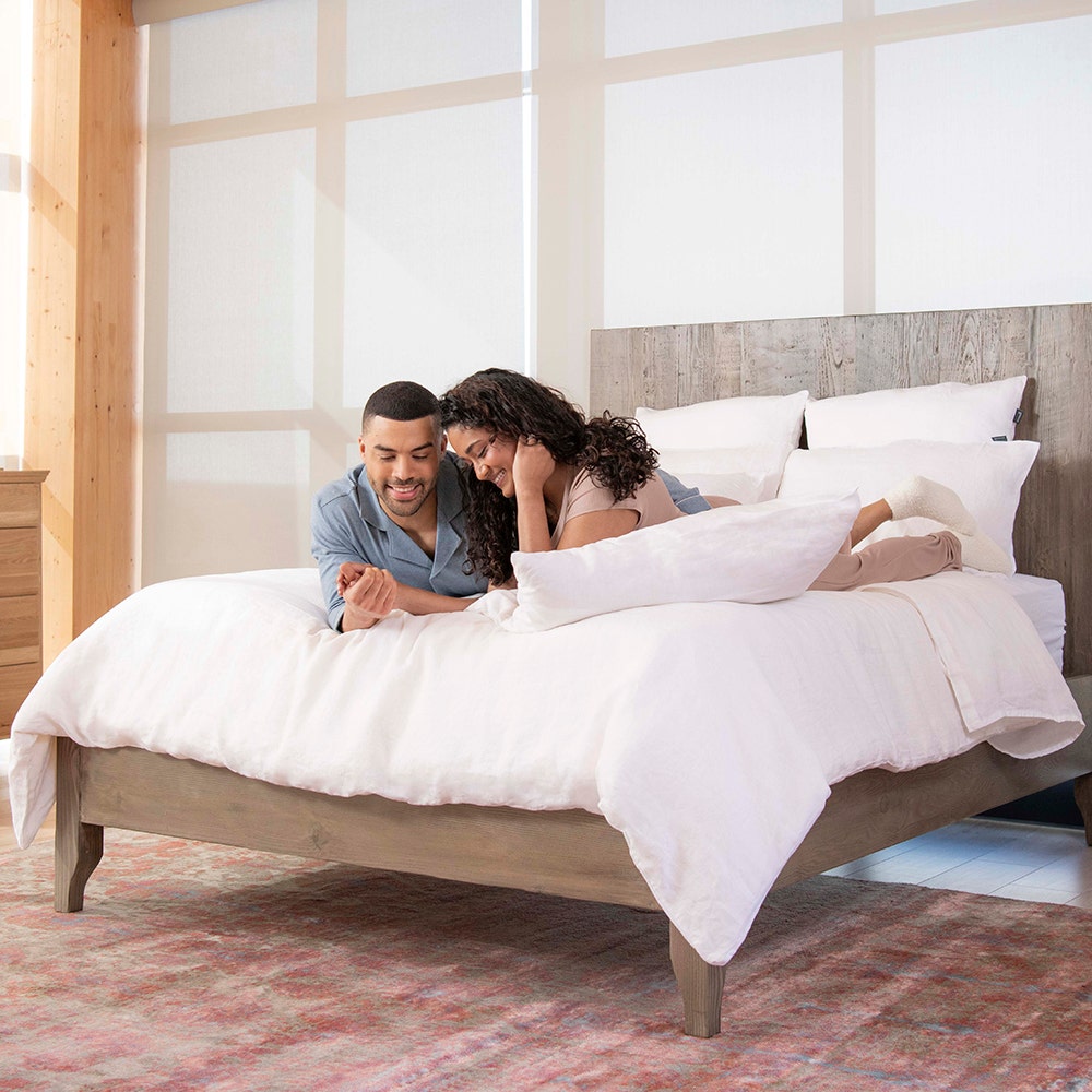 Couple in bed with linen sheets