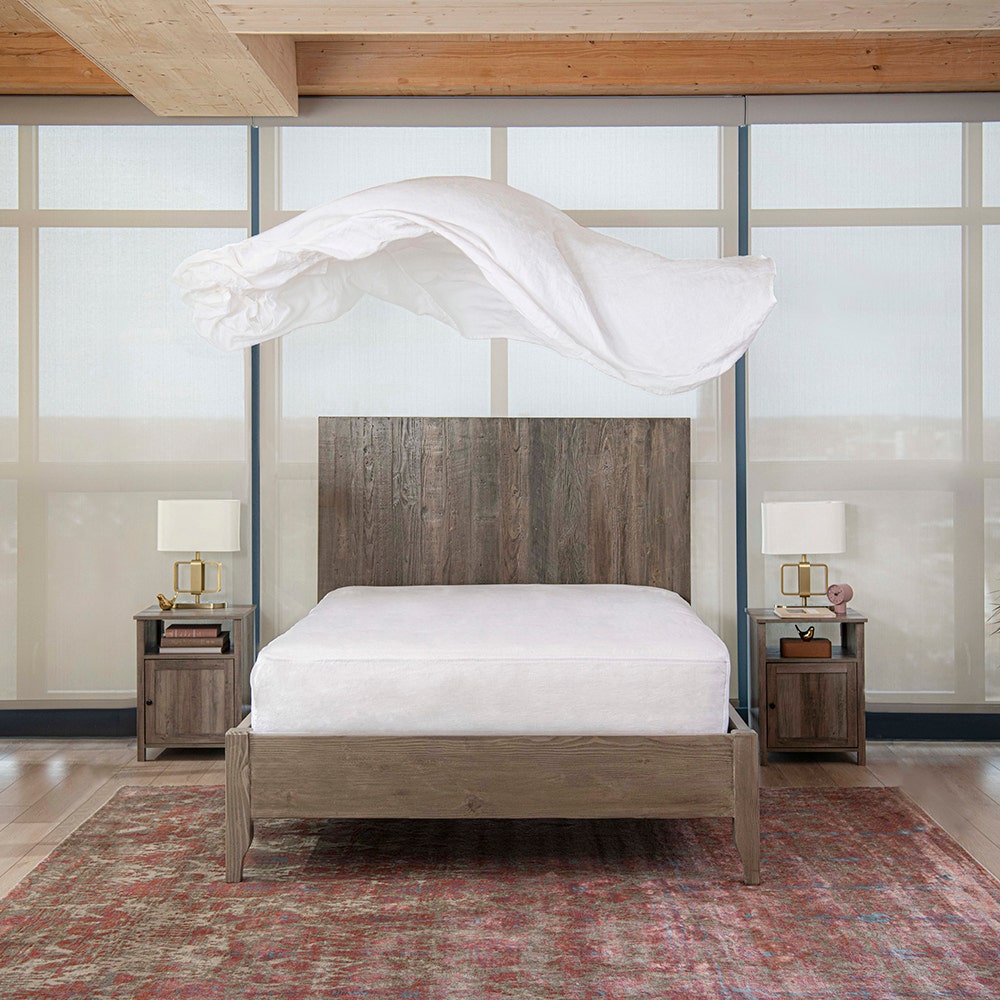Linen sheet floating above bed
