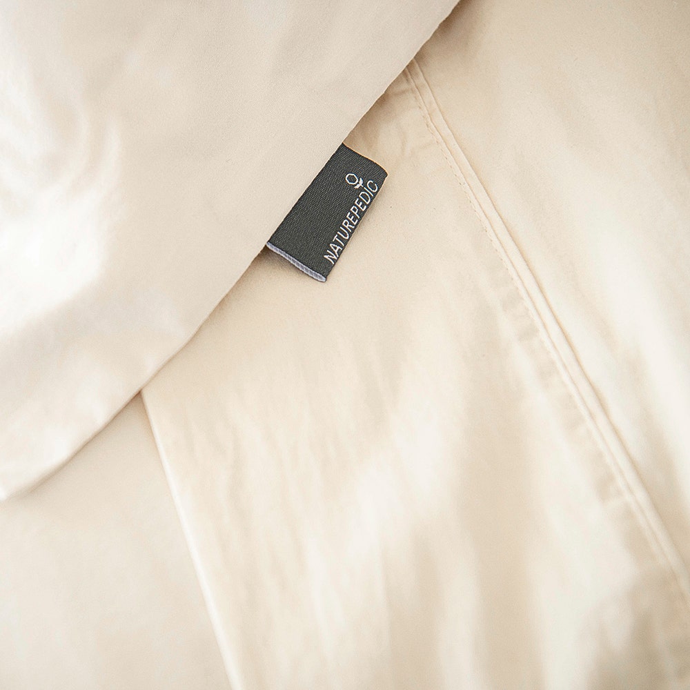 Woman wrapped in sateen sheet